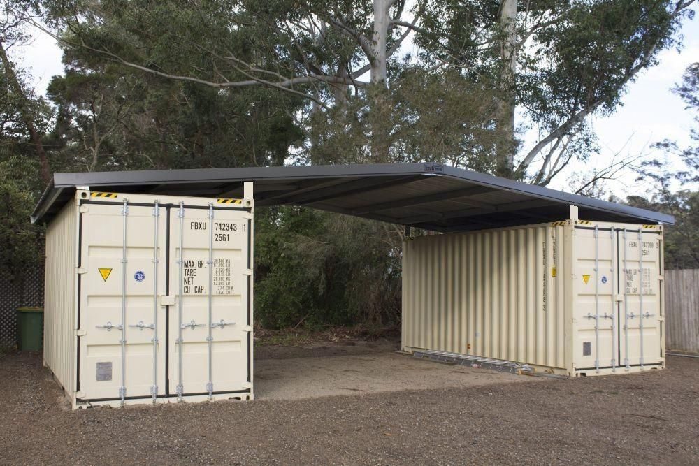 Two shipping containers set up as a garage with a covered bay between them, the kind of container garage Van Blanc delivers the units for across Ontario.