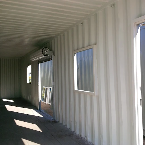 A finished container interior with a window, the kind of insulated build a producer fits out as a barrel room.