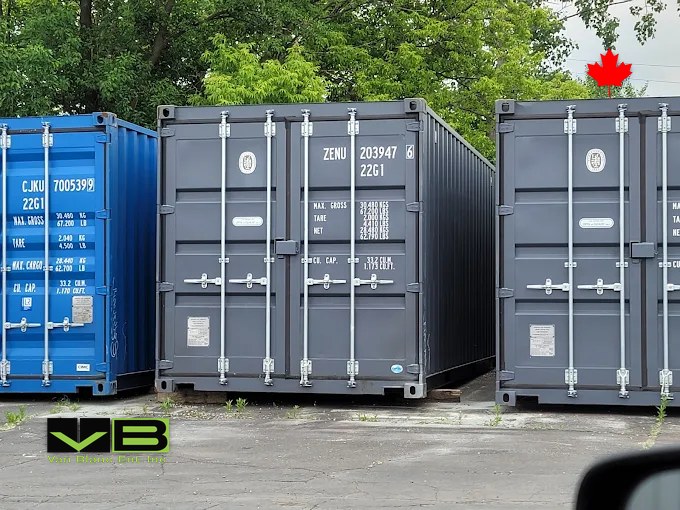 Open-side units standing in the yard with their long doors closed.