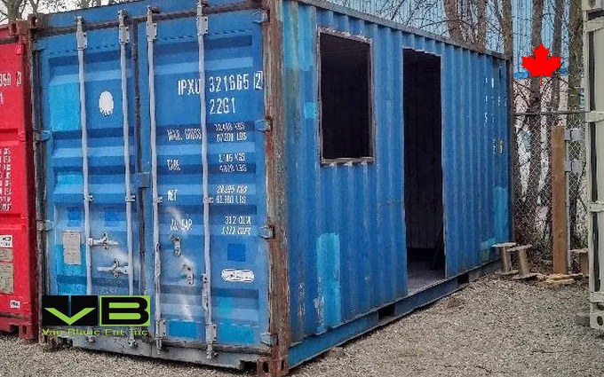 Window and doorway openings cut into a blue used container, part-way through a conversion at the Brantford shop.