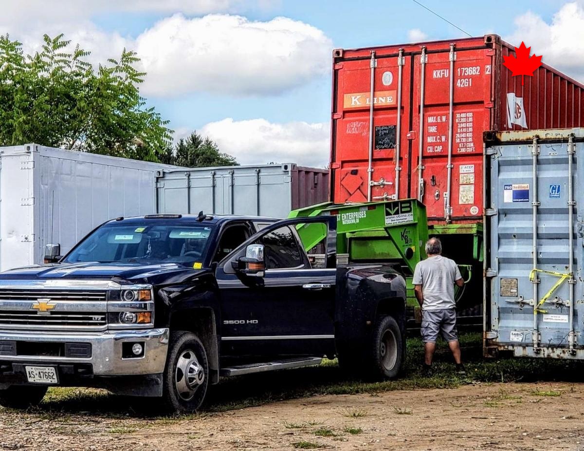 Stacked containers lining the gravel drive at the yard