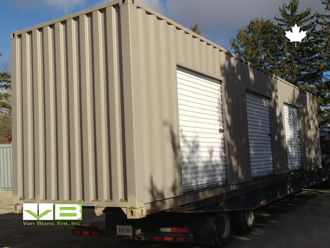 Tan unit with a white roll-up door installed, parked and ready for stock.