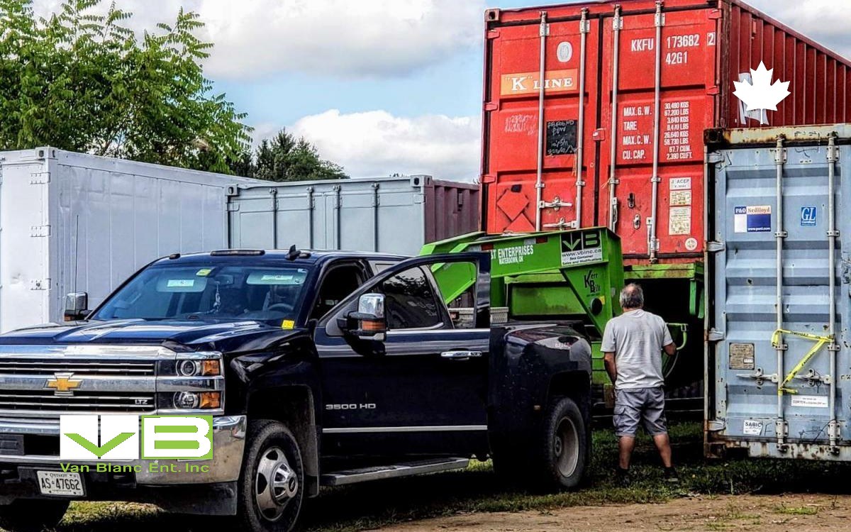 Tilt-deck truck and crew loading a container at the Brantford yard