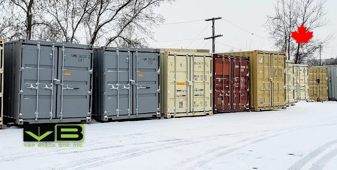 Rows of mixed inventory in the yard dusted by the season's first snow.