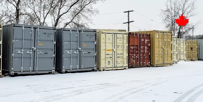 Container rows in the yard under a first snowfall