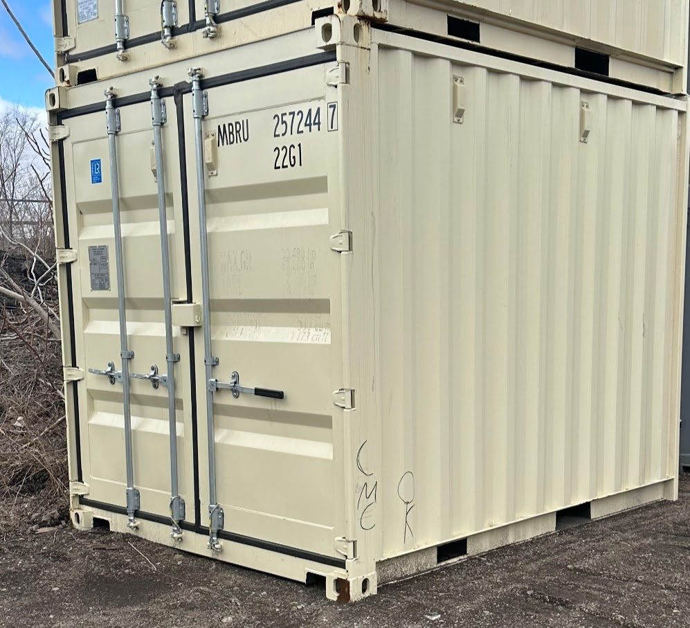 Beige cut-down container with its original 20ft cargo doors and easy handle, stacked under a matching unit on dirt ground