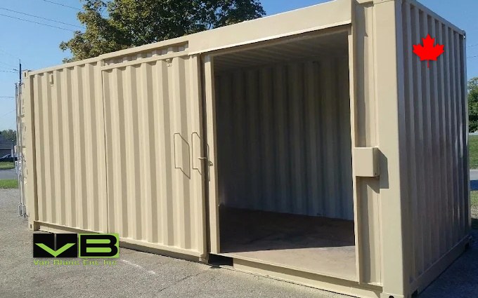 A tan unit with its side doors swung wide, empty plywood floor catching the afternoon sun.