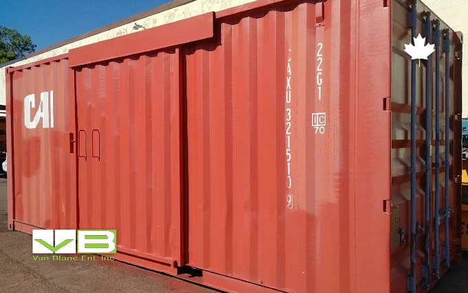 A rust-red used 20-foot unit with sliding side doors, still wearing its shipping-line markings