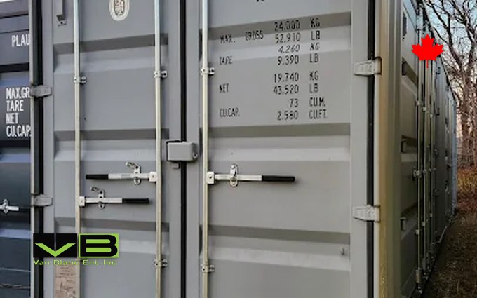 A new one-trip 40-foot high-cube shipping container seen from the door end, standing on the gravel at the yard