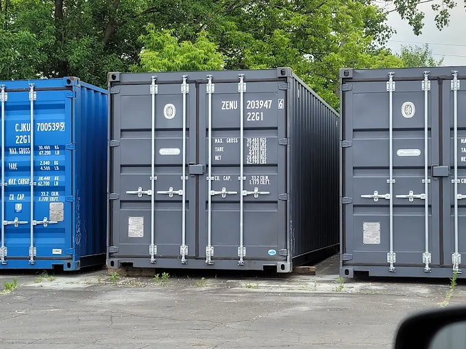 Row of open side shipping containers with their double side doors open at a container yard