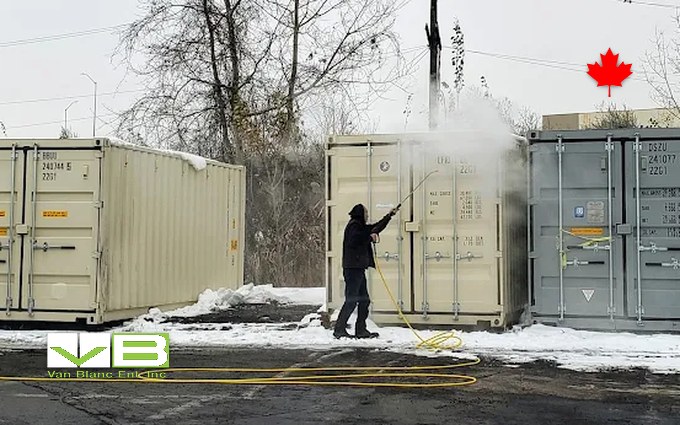 Two shipping containers standing end to end at the yard, one standard height and one high cube, showing the foot of extra height