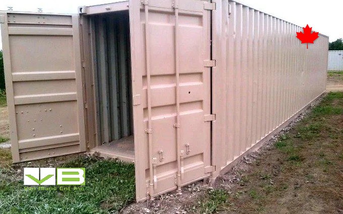 A tan 40-foot unit with one cargo door swung open, set on grass at the edge of a growing property