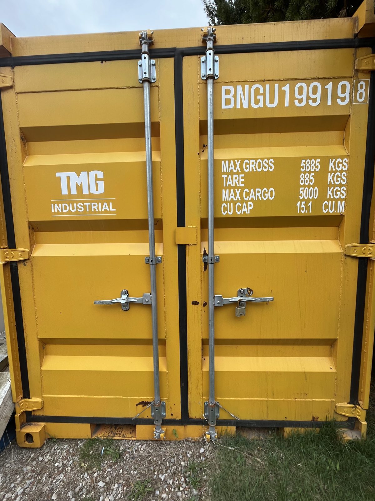 Yellow cargo doors on a 9ft before its repaint, with white stencilled lines for max gross, tare, max cargo and cubic capacity and a padlocked locking bar